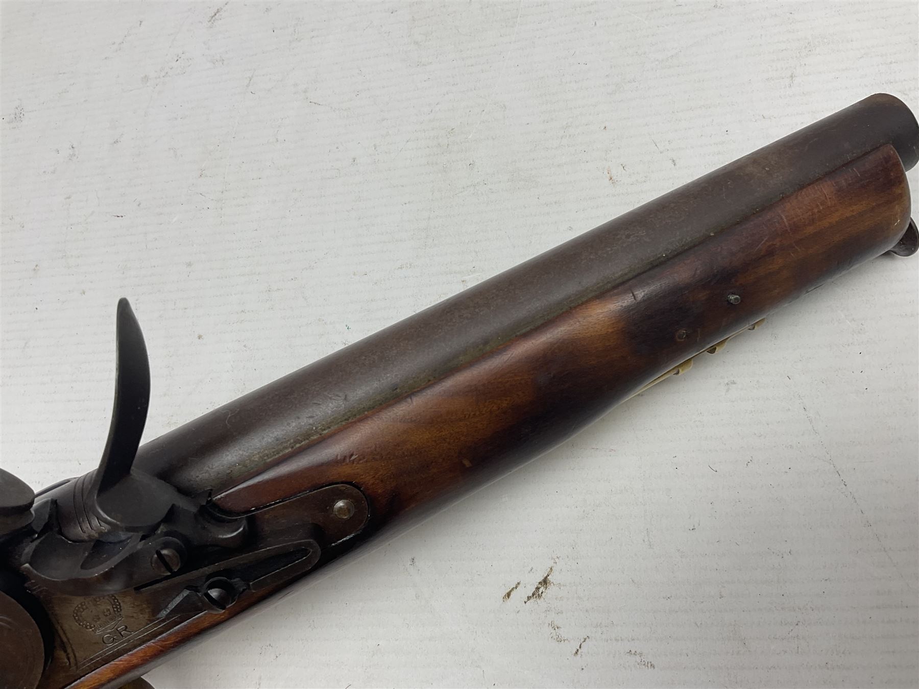 Modern non-firing reproduction Tower flintlock pistol marked with crowned GR and Tower to the lock, brass skull crusher butt and fittings L40cm overall; another Indian/Moorish reproduction flintlock pistol with mother-of-pearl inlay; and a modern die-cast replica Colt style revolver (3)