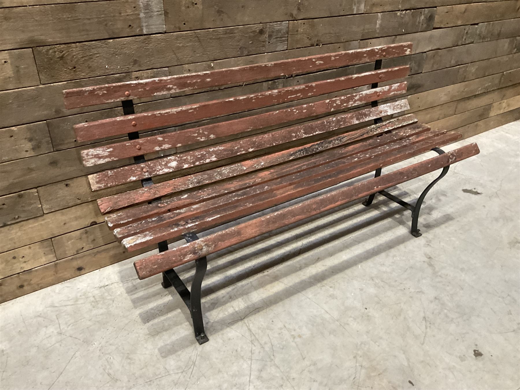 Wrought metal and wood slatted garden bench