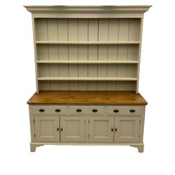 Victorian pine dresser, raised painted three heights plate rack with projecting cornice, waxed top over pained base fitted with three drawers and two double cupboards, bracket feet