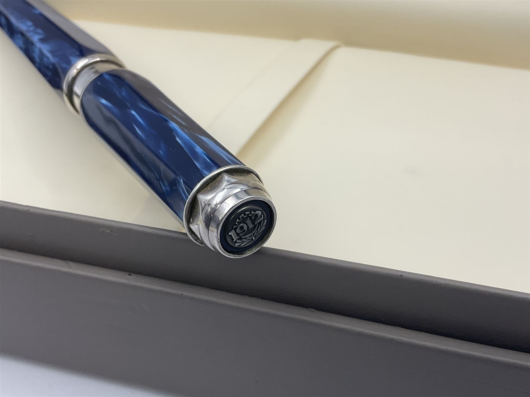 Montegrappa Emblema fountain pen, the blue pearl marbled barrel of octagonal form with silver mounts stamped 925 and silver mounted cap with 1912 emblem and clip with roller, in box, L13.5cm