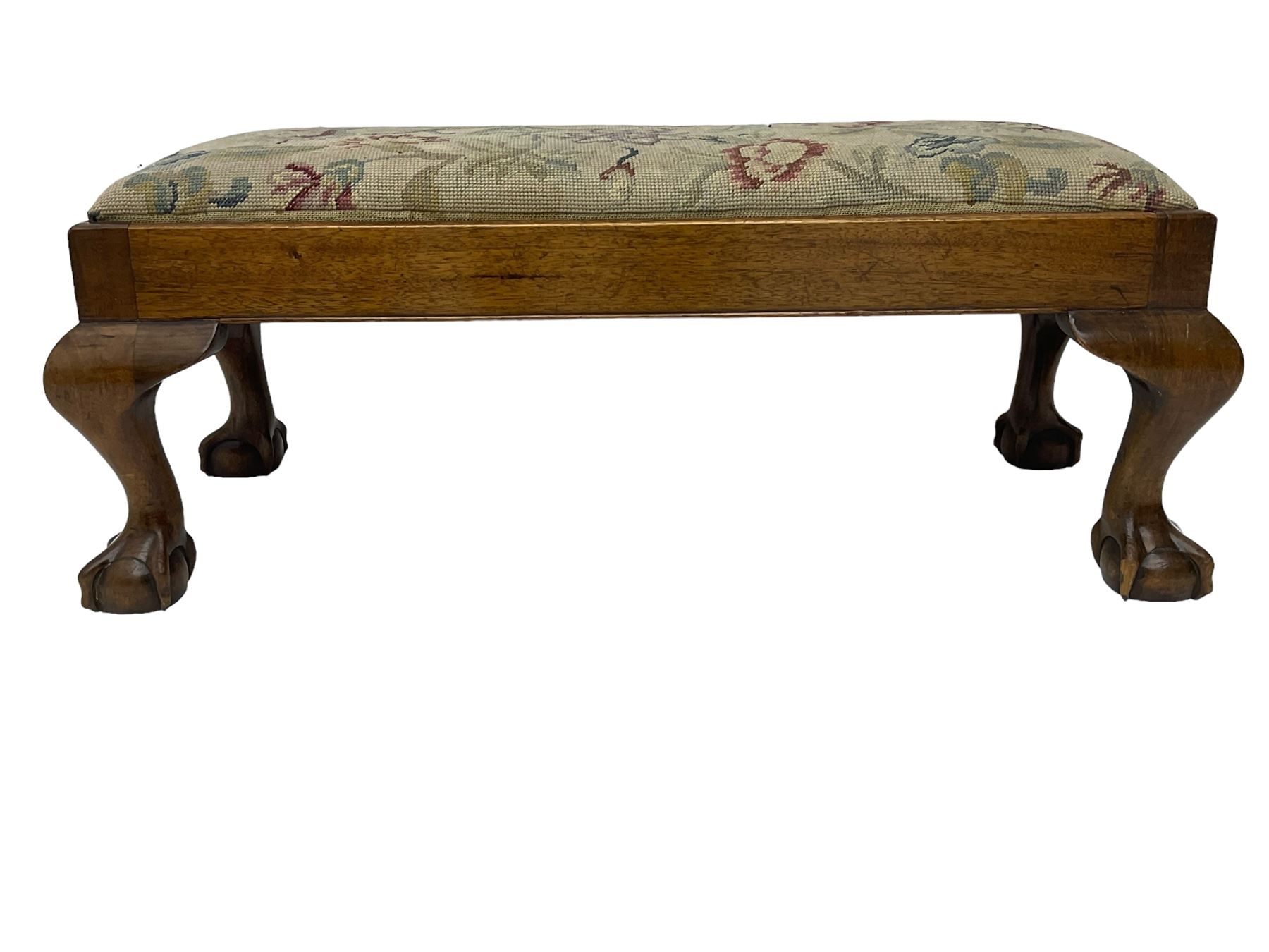 20th century mahogany rectangular footstool, needlework upholstered drop-in seat, on ball and claw carved feet (W81cm, D35cm, H34cm); 19th century elm stool, needlework upholstered drop-in seat, on square moulded supports united by plain stretchers (W45cm); 19th century walnut stool, shaped top upholstered in needlework, on cabriole supports (W50cm); 19th century rosewood stool, upholstered drop-in seat, on curved x-framed supports united by turned stretcher (W47cm)