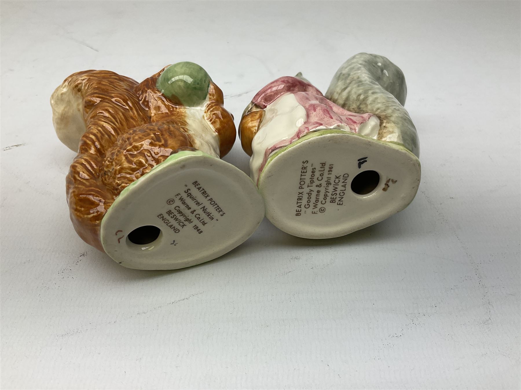 Seven Beswick Beatrix Potter figures, comprising, The old woman who lived in a shoe, Anna Maria, Samuel Whiskers, Johnny Town-Mouse, Timmy Tiptoes, Goody Tiptoes and Squirrel Nutkin, all with printed mark beneath 