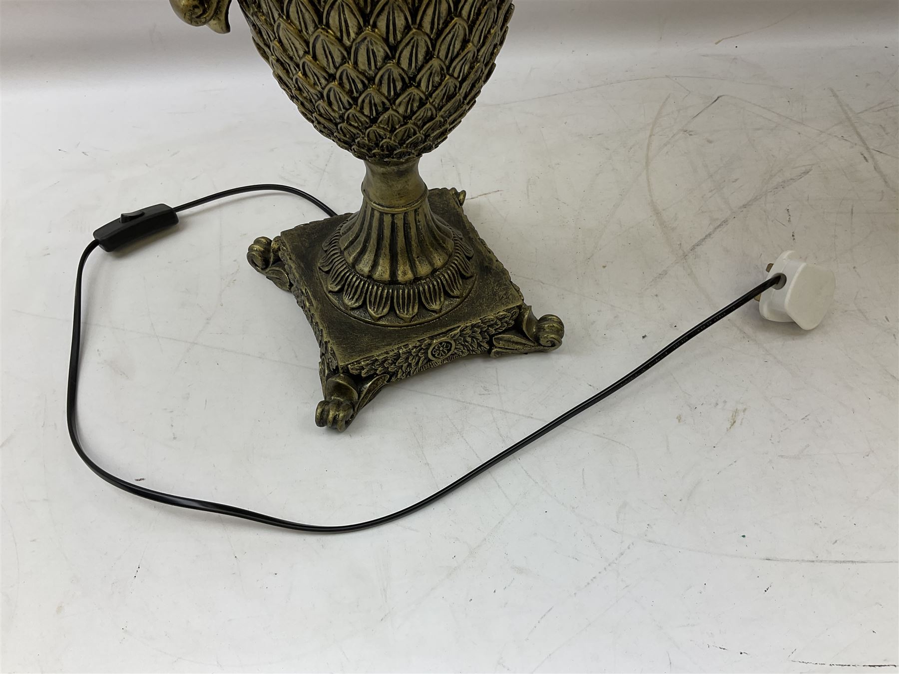Pair bronzed amphora lamps with pineapple decoration, scroll handles and foliate base with scrolled feet together with pair peach ground shades and raised floral pattern H76cm (2)