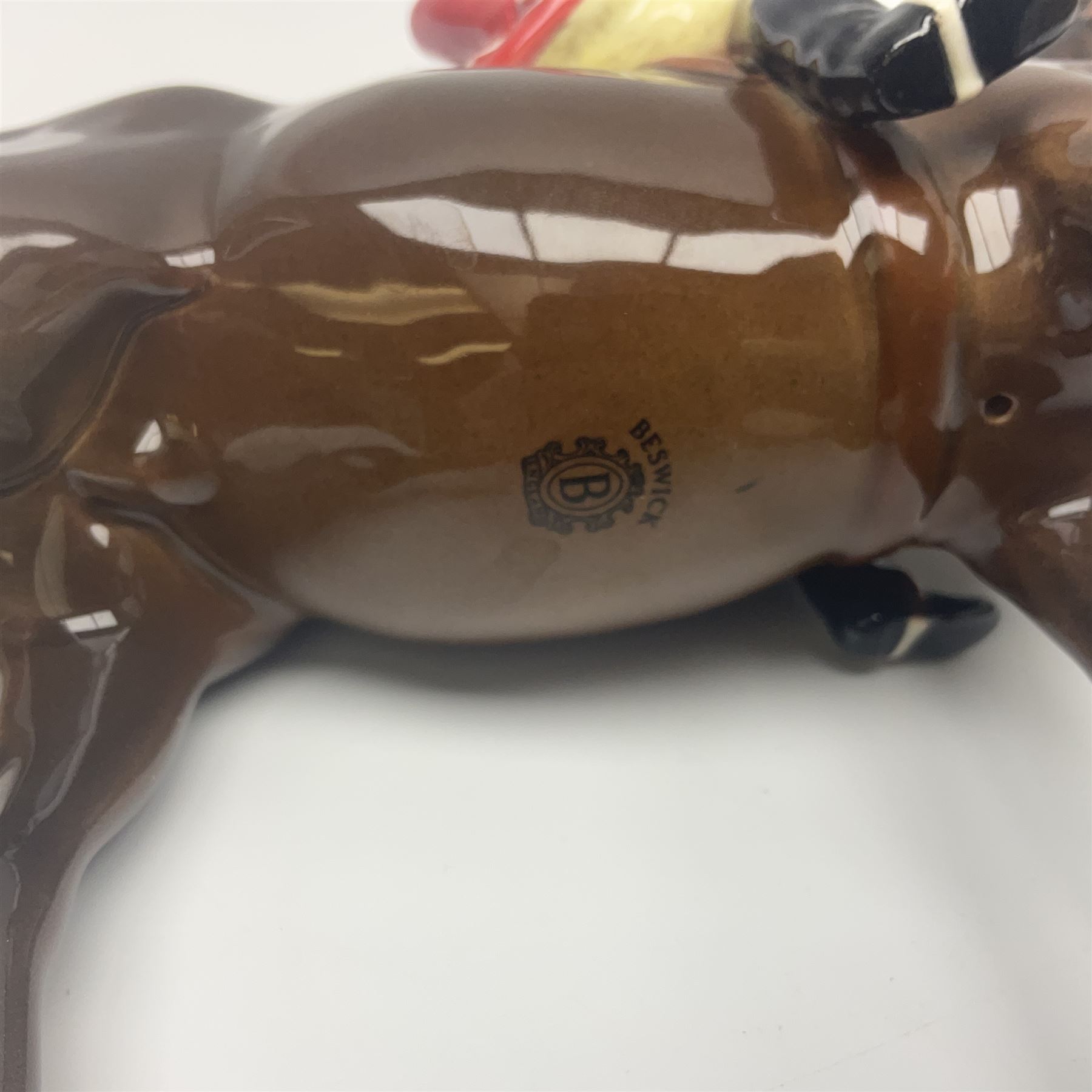 Beswick hunting group, comprising huntswoman on grey horse no 1730, huntsman on brown horse no 1501, fox figure no 1440 and eight fox hounds, all with printed marks beneath (11)