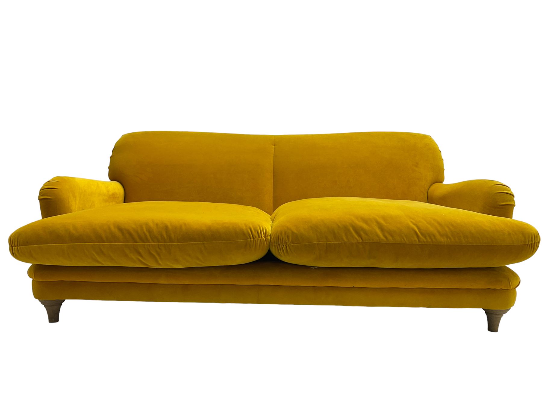 Loaf - large two seat 'Jonesy' sofa, upholstered in mustard velvet fabric with sprung back and loose seat cushions, raised on pale oak turned supports