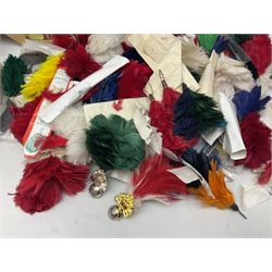 Quantity of military horse hair plumes and feather hackles, cloth stripes and regimental titles etc
