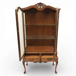 Queen Anne design walnut display cabinet, carved cartouche above two glazed doors enclosing two fixed glass shelves, over two frieze drawers above a heavily carved apron with cabriole supports