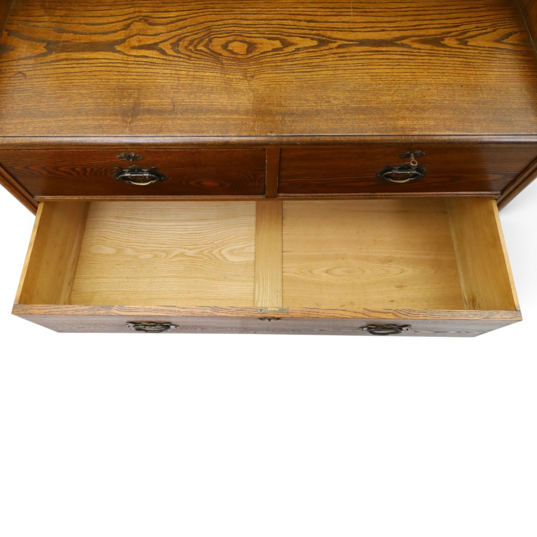 Shapland & Petter - oak mirrored dressing chest, tilted mirror flanked by tulip carved supports, shaped shelves with heart cut outs, above two short over one long drawers, with brass handles and stamped S & P on the locks, raised on shaped supports