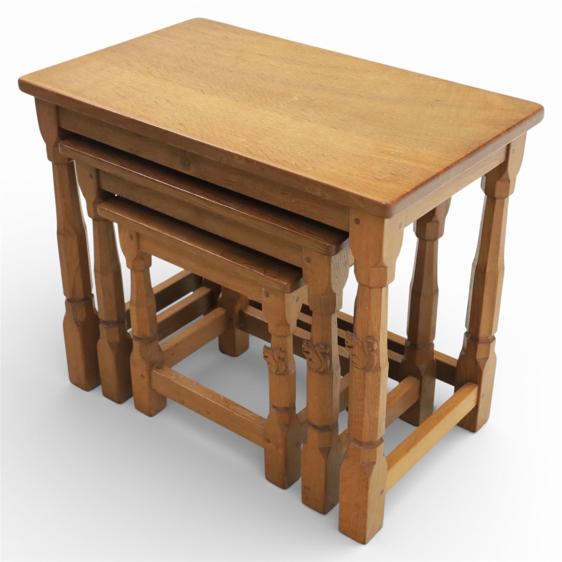 Squirrelman - nest of three tables, each with rectangular top upon octagonal turned supports with squirrel carving, by Wilfrid Hutchinson, Husthwaite