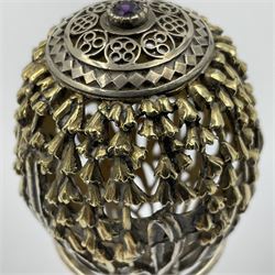 Modern silver limited edition Easter egg, no. 70/500, the gilt openwork body decorated with cascading bluebells and hinged cover with pierced circular panel set with a single faceted purple stone, opening to reveal a gilt interior, upon silver stand with three scrolling pad feet, each hallmarked St James House Company, London 1981, height including stand 8cm