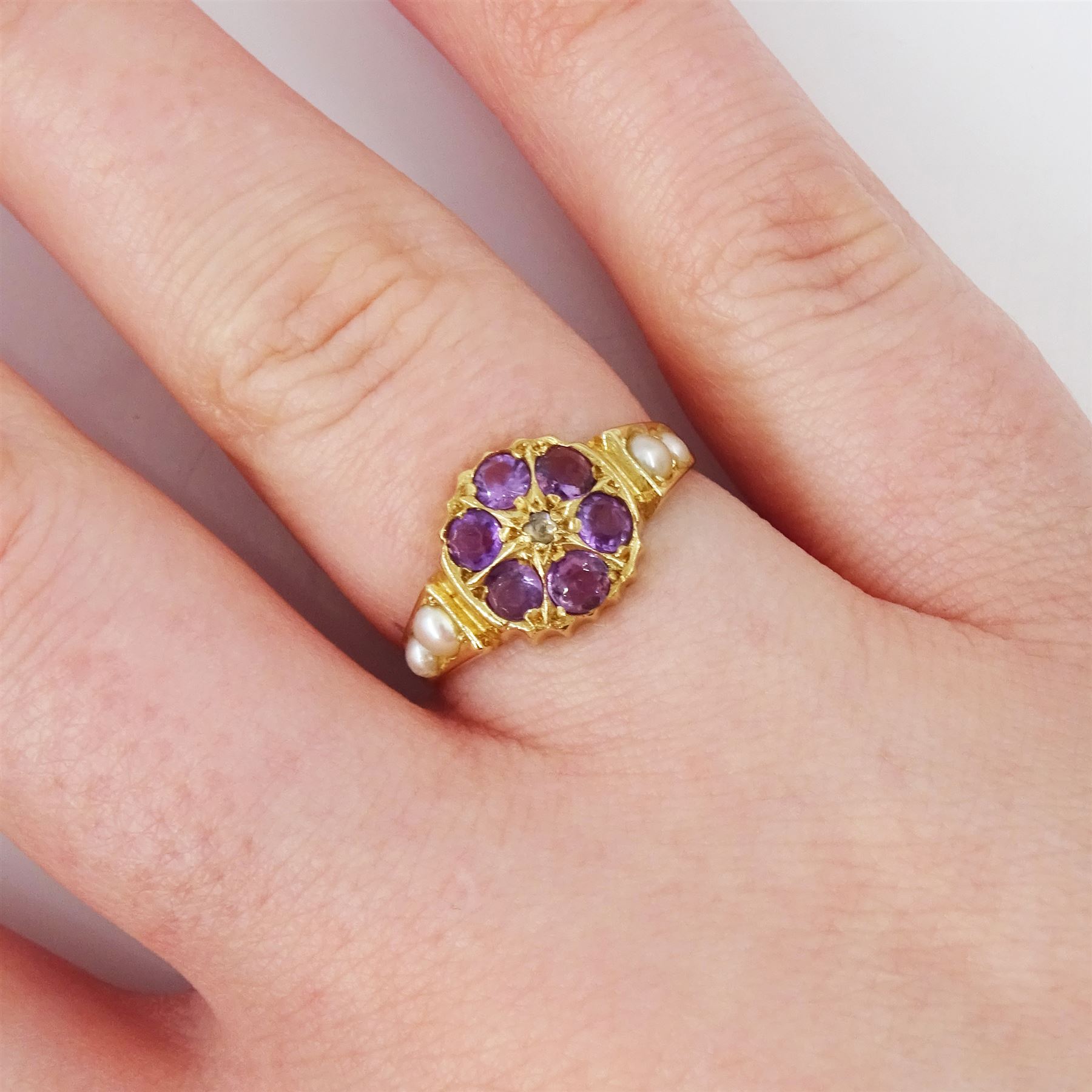 14ct gold amethyst, diamond and pearl ring, single rose cut diamond, surrounded by six round cut amethysts, the shoulders with two split pearls set either side