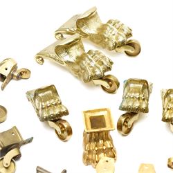 Set of four period design lacquered brass paw furniture castors by Beardmore, London, set of four matching smaller castors and a quantity of various brass castors   
Provenance: property of a Nobleman