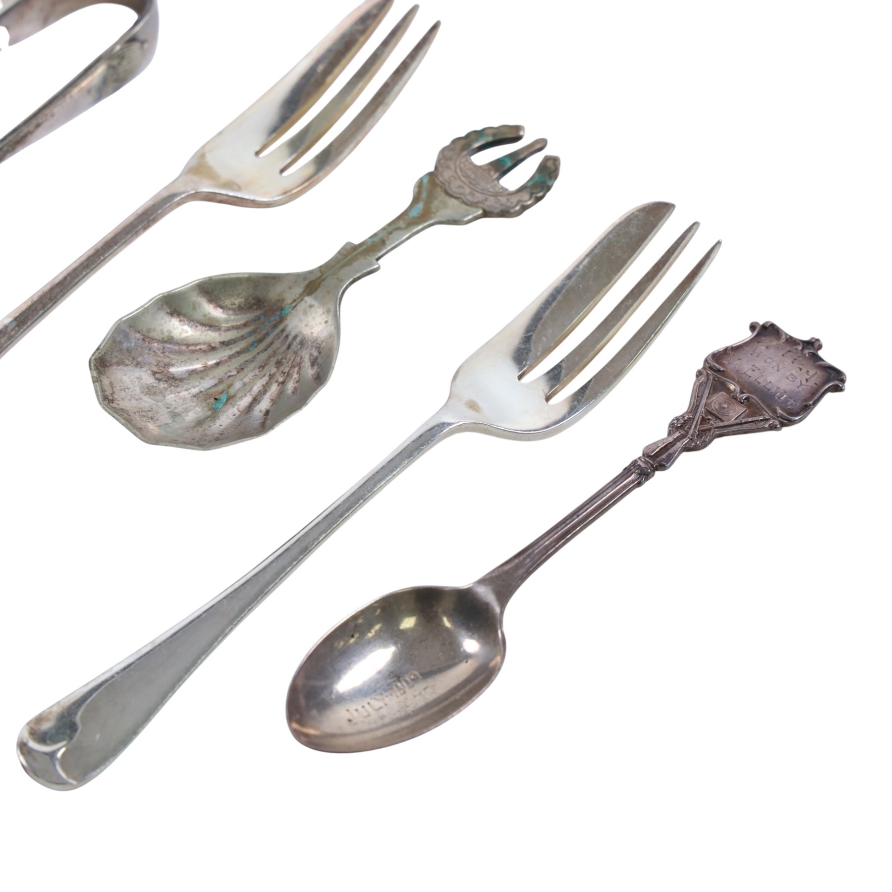 Silver dessert spoon, silver souvenir spoon, silver handled fish knife and two silver napkin rings, together with a collection of silver plated cutlery