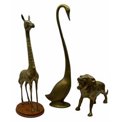 Large brass figure of a lion H29cm, together with a brass swan, and brass giraffe on wooden plinth H74cm. 