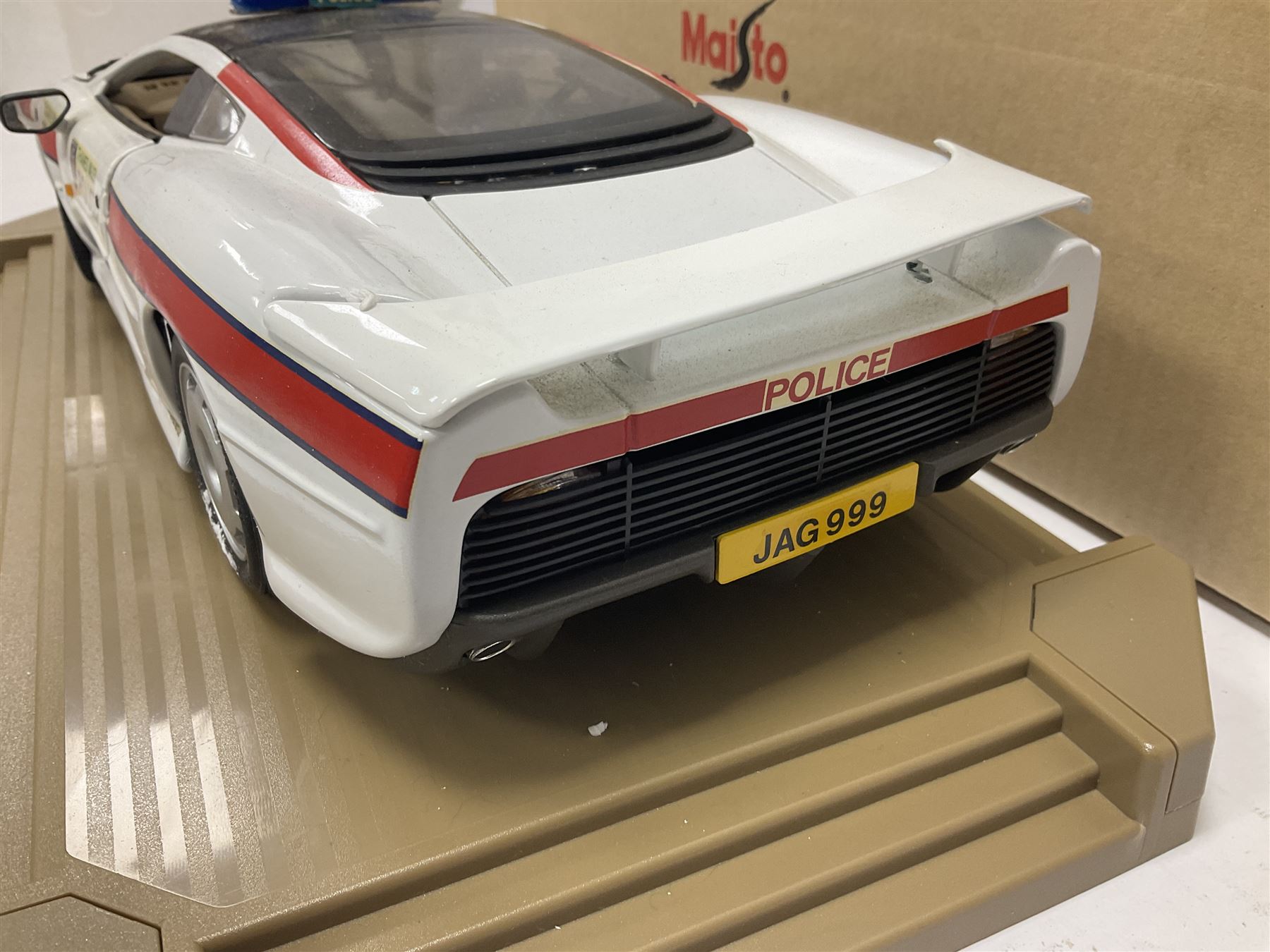 Two Maisto 1:12 scale Jaguar XJ220 scale cars comprising 1992 ‘Concept Car’ West Midlands Police car and 1994 ‘Jag 999’ Thames Valley Police Traffic Car, both on plinths with original boxes and certificates of authenticity 