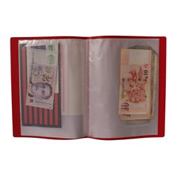 Great British and World banknotes, including many uncirculated examples, housed in ten folders