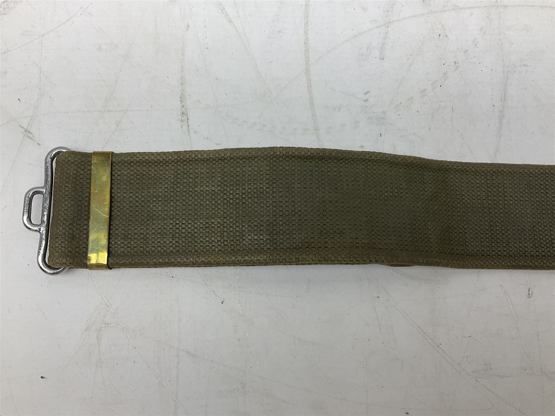 British Army Officers Sam Browne leather belt with shoulder strap; and webbing belt with Potter London Staybrite buckle for 19th Regiment of Foot (Green Howards) with various markings (2)