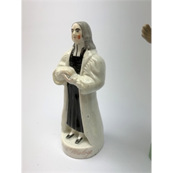 Three 19th century Staffordshire pottery figures, each modelled as John Wesley, largest H20.5cm.