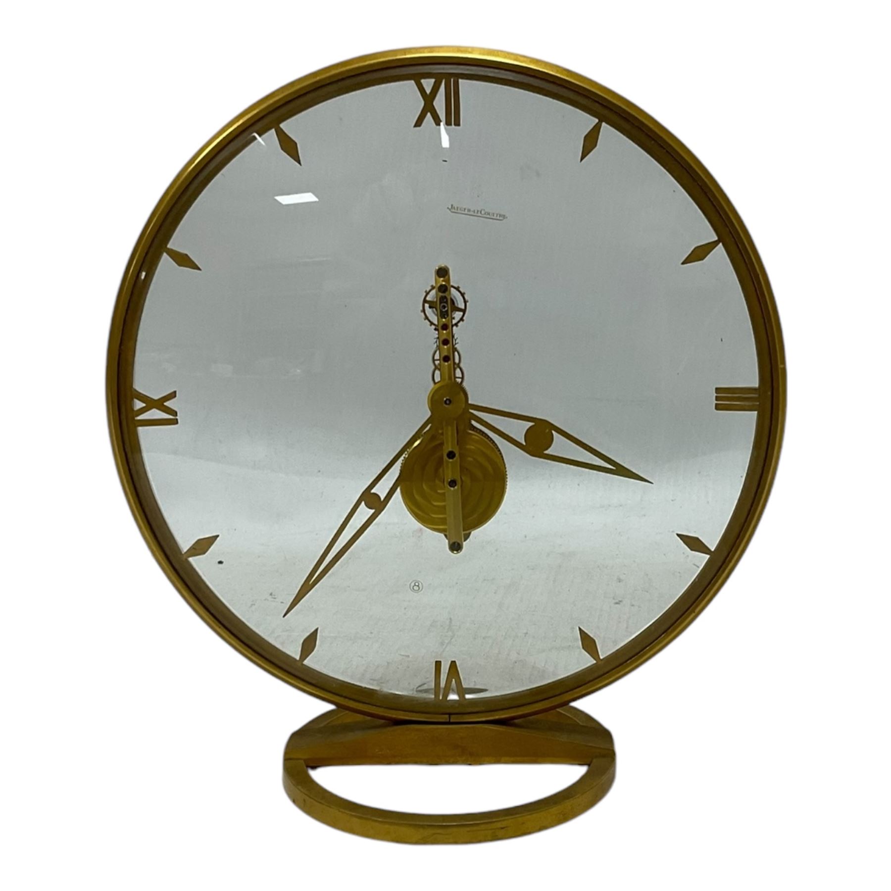 Jaeger Le Coultre- 8-day  Art Deco style circular skeleton clock c1960, gold plated case with translucent dials to the front and rear displaying the 16 jewelled Swiss movement and lever balance. Wound and set from the rear.