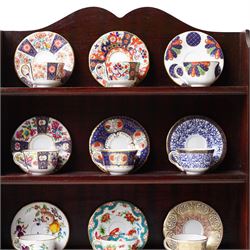 Royal Worcester miniature cups & saucers collection, 1993,  various patterns on display shelf, with certificates, shelf H49cm