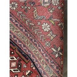 Persian Karajeh red ground runner, decorated with multiple stylised medallions and motifs