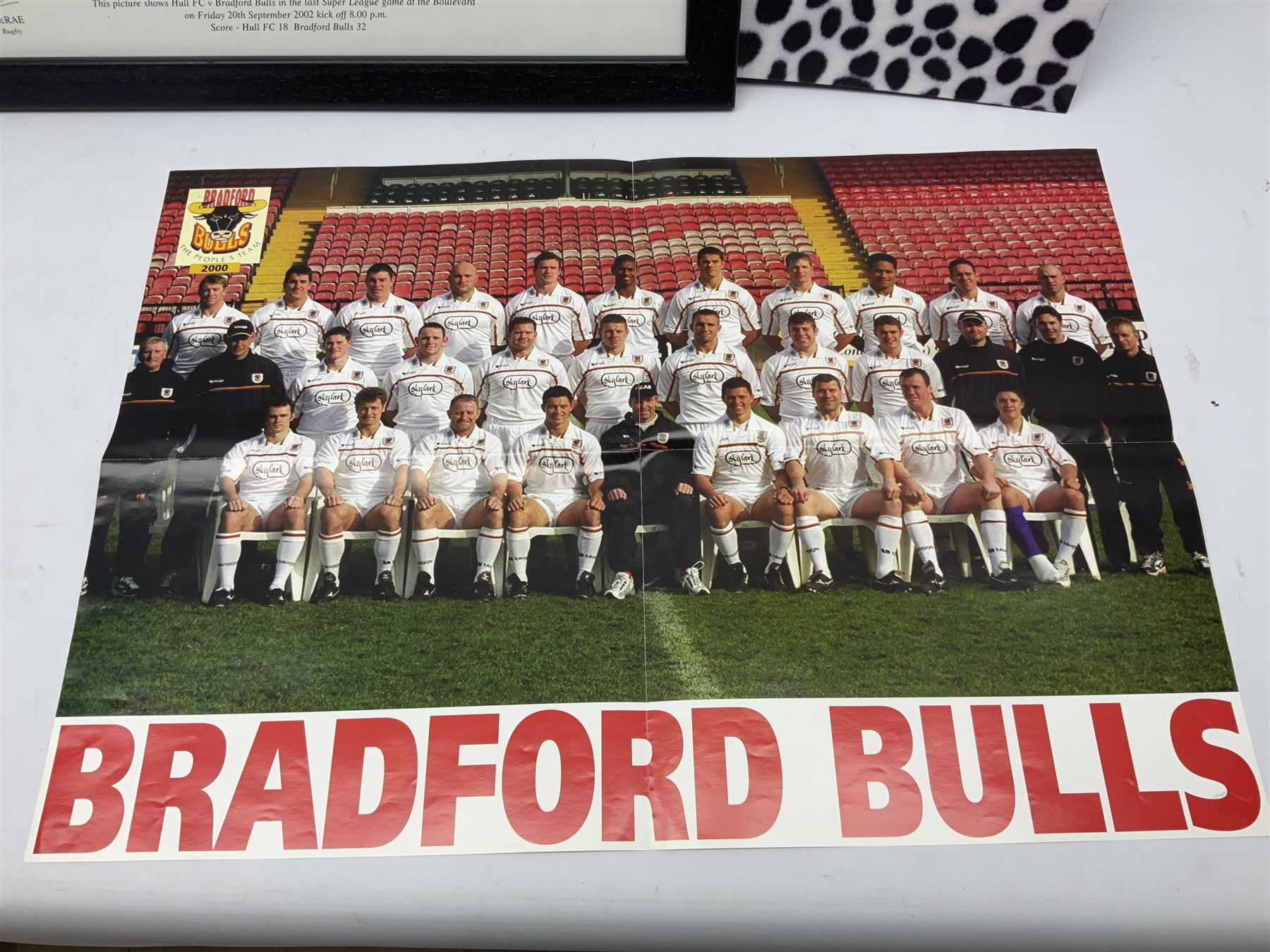 Hull F.C. memorabilia; Clive Sullivan 1986 memorial game programme, Open Evening 1994 programme with multiple player signatures, 'Old Faithful' 45rpm record, Wembley rosettes, 2000 team poster with facsimile signatures, framed print 'Farewell to the Boulevard 1895-2002', fully signed team photograph, various booklets, CD, DVD etc; and a folder containing the Merlin Rugby League card collection