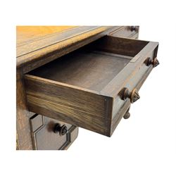 Early 20th century Jacobean design oak desk, with rectangular top inset with worn tooled leather, two frieze drawers over pedestals each fitted with a pair of panelled drawers, turned handles, on carved and fluted tapering legs united by stretchers 