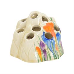 Royal Staffordshire Crocus by Clarice Cliff teacup and saucer, with printed mark beneath, together with a Clarice Cliff Crocus pattern flower frog, with printed mark beneath, cup H6cm