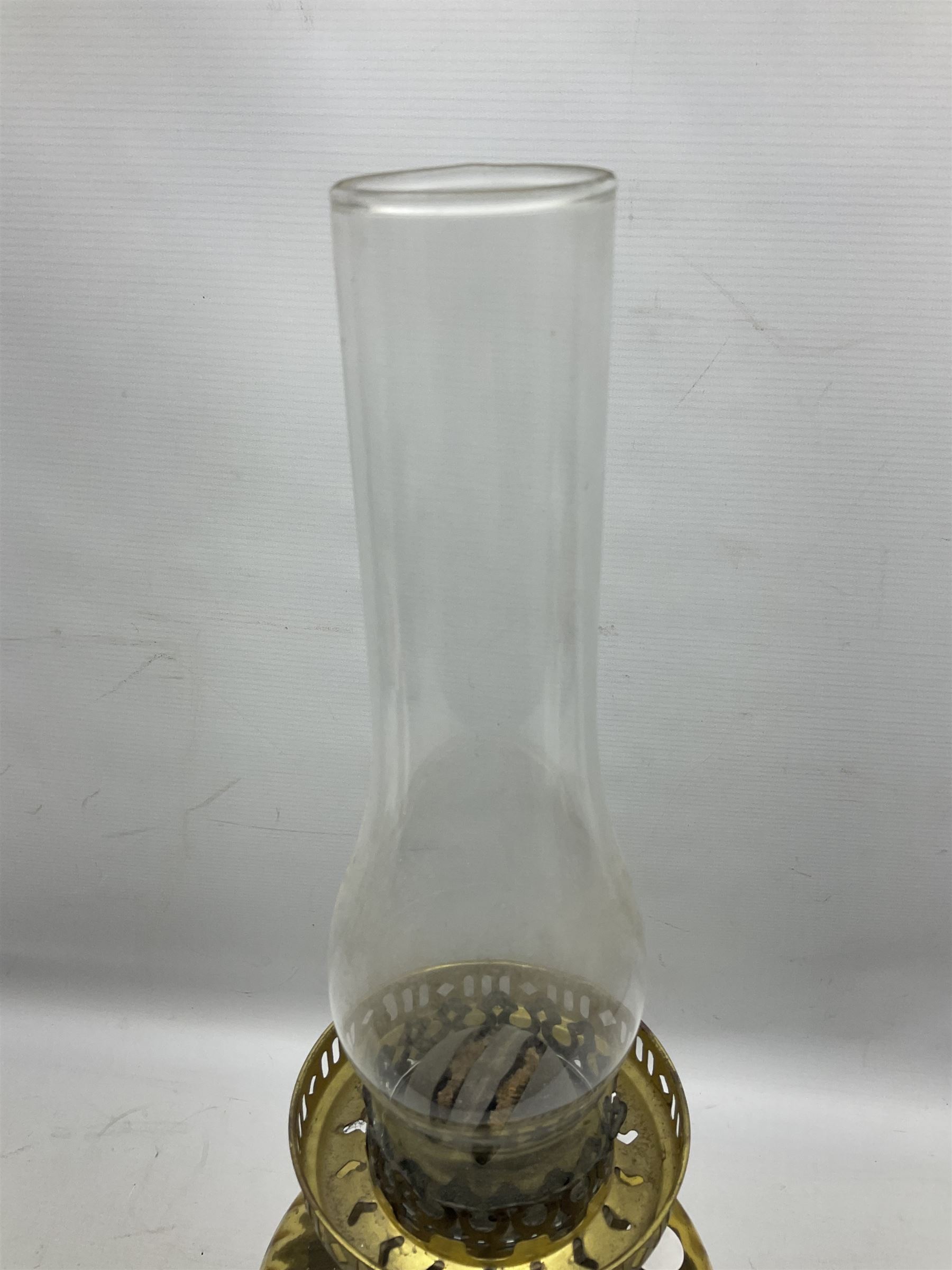 Victorian cast spelter oil lamp, decorated with cherubs and foliate scrolls, supporting a glass reservoir, burner and clear glass chimney, H62cm