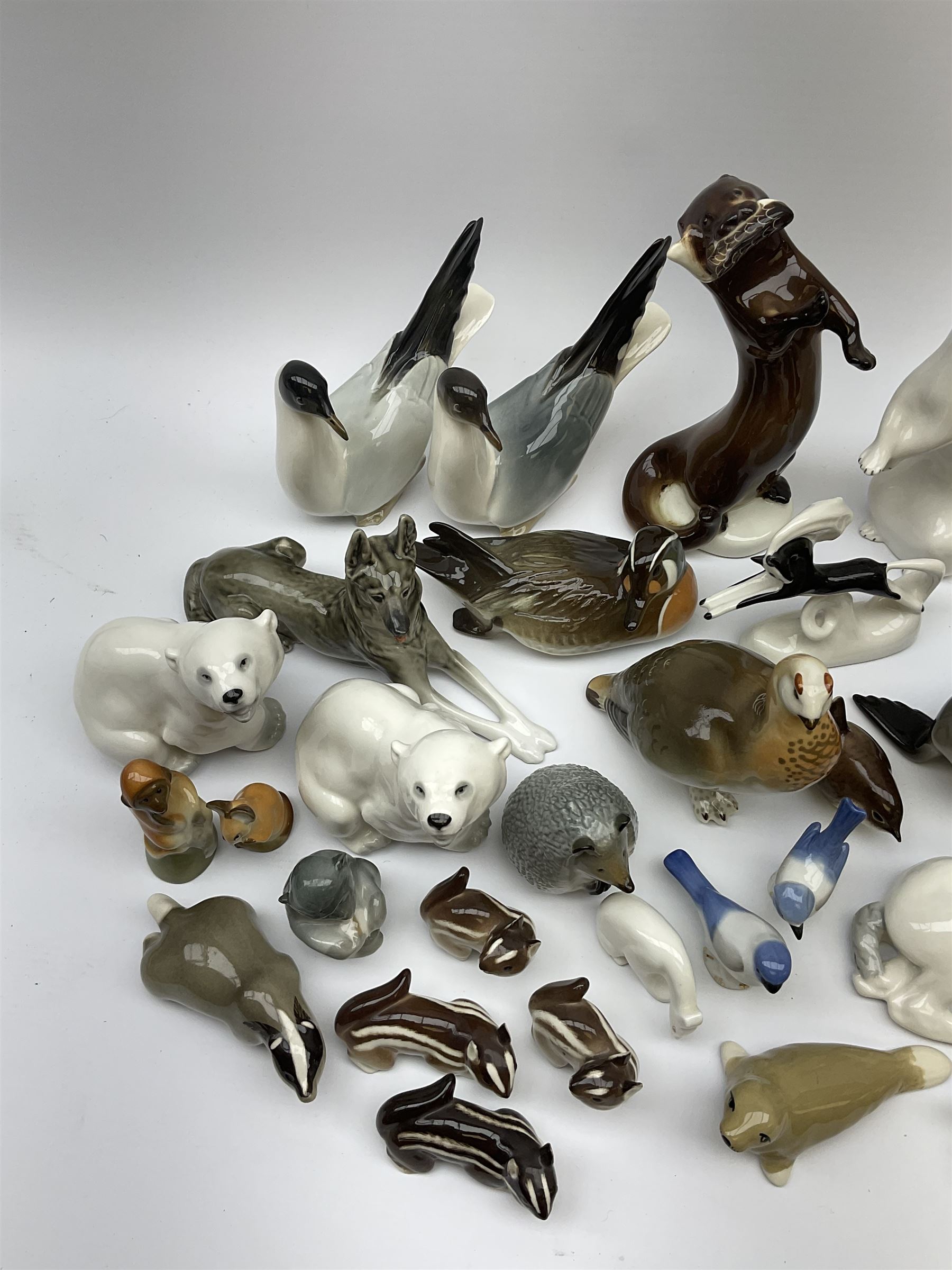 A collection of Russian animal figures, largely comprising Lomonosov examples, to include examples modelled as otters, seals, polar bears, horse, various birds, wolf, hedgehog, etc. 