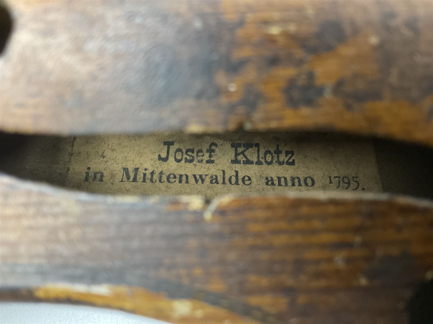 Late 19th century Saxony violin with 36cm one-piece maple back and ribs and spruce top; bears label 'Josef Klotz in Mittenwalde Anno 1795' L60cm overall; in ebonised wooden 'coffin' case