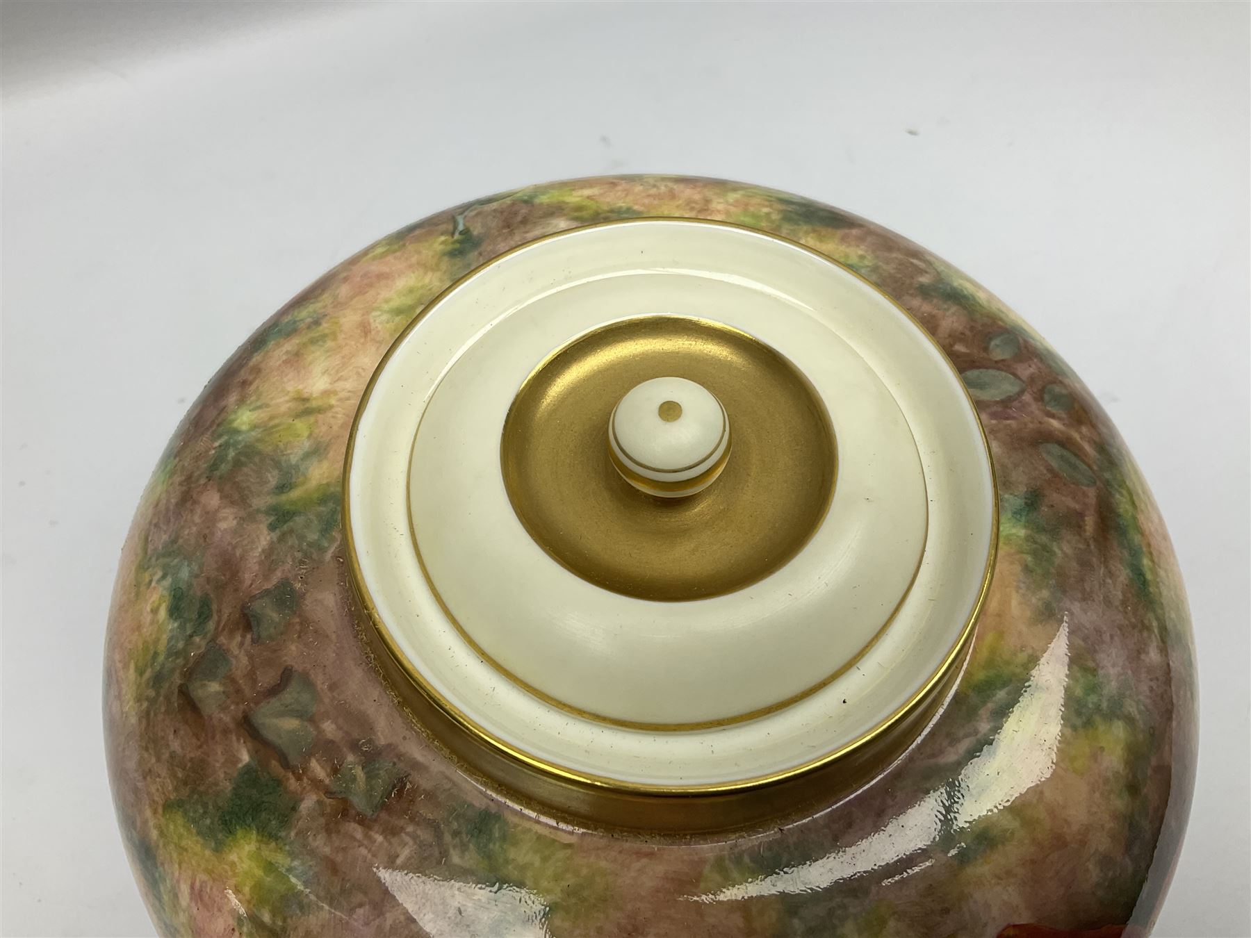 Mid 20th century Royal Worcester potpourri vase and cover decorated by Alan Telford, of ovoid form with inner cover and pierced gilt outer cover with bud finial, upon short gilt circular foot, the body part moulded with basket weave bands in gilt and bronze, and hand painted with a still life of fruit upon a mossy ground, signed Telford, with black printed mark beneath and painted shape number 1286, H25.5cm