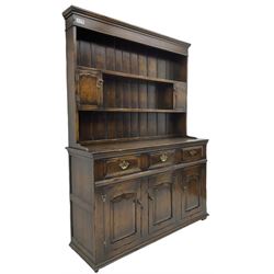 Georgian design oak dresser, the two-tier plate rack with two flanking spice cupboards, the base fitted with three drawers over three arched fielded panelled cupboards, lower moulded edge on block feet