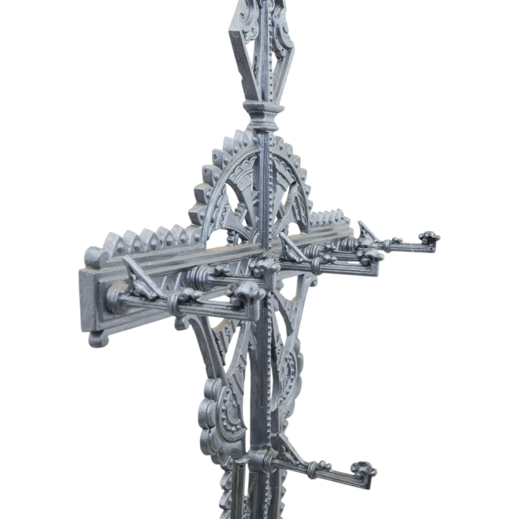 Late 19th century cast iron hall stand in the style of Christopher Dresser, cross shaped upper section with radiating wheel motif and applied hooks, architectural upright with pierced Gothic and geometric detail, fitted with rectangular drip tray and pierced surround, raised on stepped plinth base with bead decoration