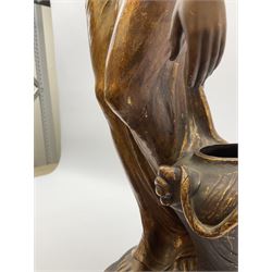 An Art Nouveau Goldscheider pottery figure, modelled as a classical female figure stooping to lift a water jar, matt glazed and highlighted in gilt, signed to base E Tell, H64cm. 
 