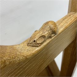 Mouseman - oak magazine rack, the top rail pierced with handle and carved with mouse signature, octagonal supports with two panelled and splayed sides, on sledge feet, by the workshop of Robert Thompson, Kilburn 