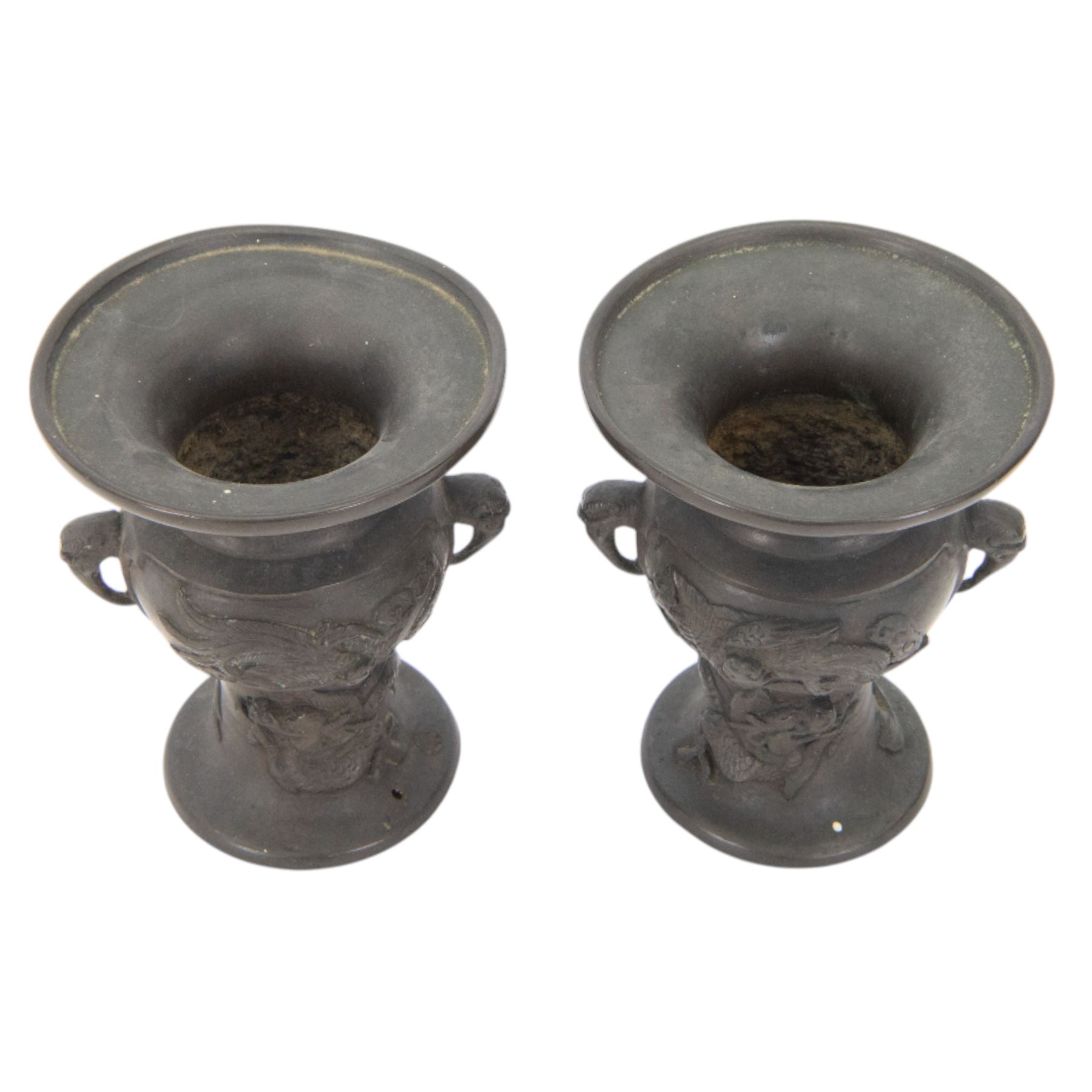 Pair of Japanese bronzed vases, decorated in relief with with birds and dragons, with dragon head handles, H13cm