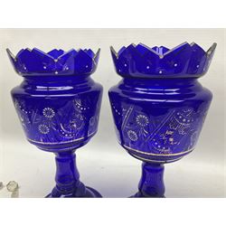 Pair of blue glass lustre vases, painted with white and gilt floral decoration, H32cm