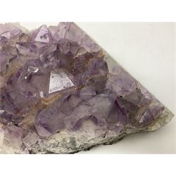 Amethyst crystal geode cluster, with well-defined crystals of various sizes, H10cm, L30cm
