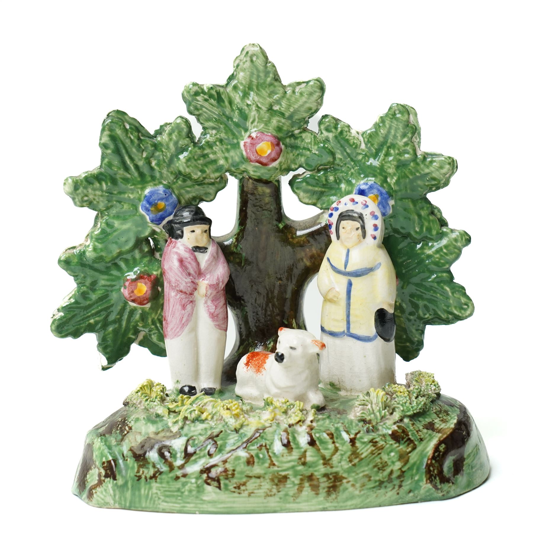 Pair of 19th century Staffordshire sheep, W13cm; together with a pearlware bocage group, H12cm (3)