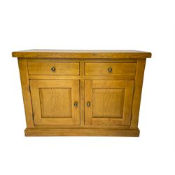 Solid light oak sideboard, rectangular top fitted with two drawers and two cupboards with panelled fronts, on plinth base