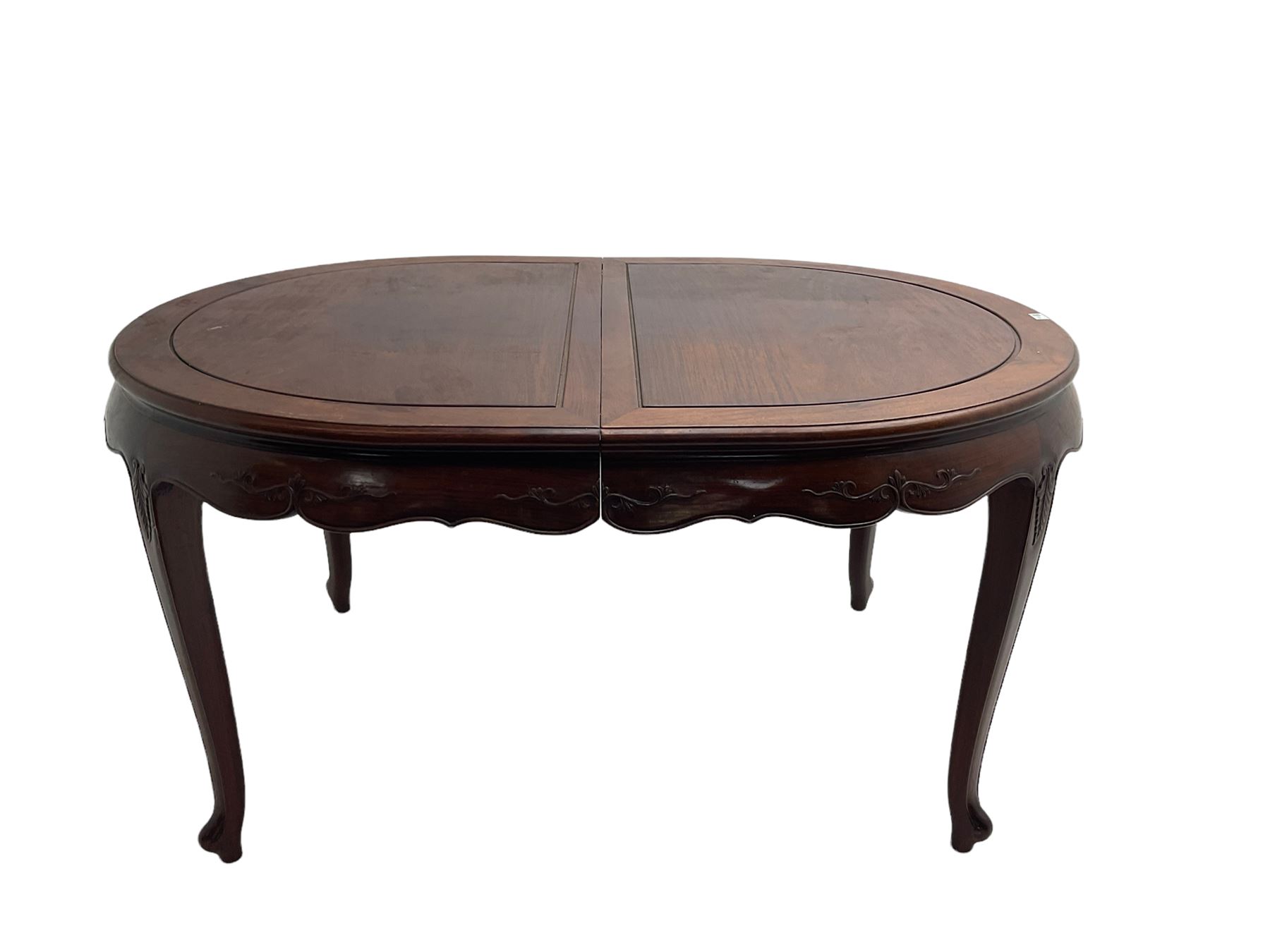 Mid to late 20th century Chinese hardwood extending dining table, two additional leaves, shaped apron carved with foliate scrolls, leaf carved cabriole supports (W246cm, H78cm, D117cm), and set six (4+2) dining chairs with shaped cresting rails over carved splats