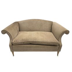 Traditional two seat sofa, curved back over scrolled arms, upholstered in crushed beige fabric with matching loose cushions, on turned front supports with brass and ceramic castors