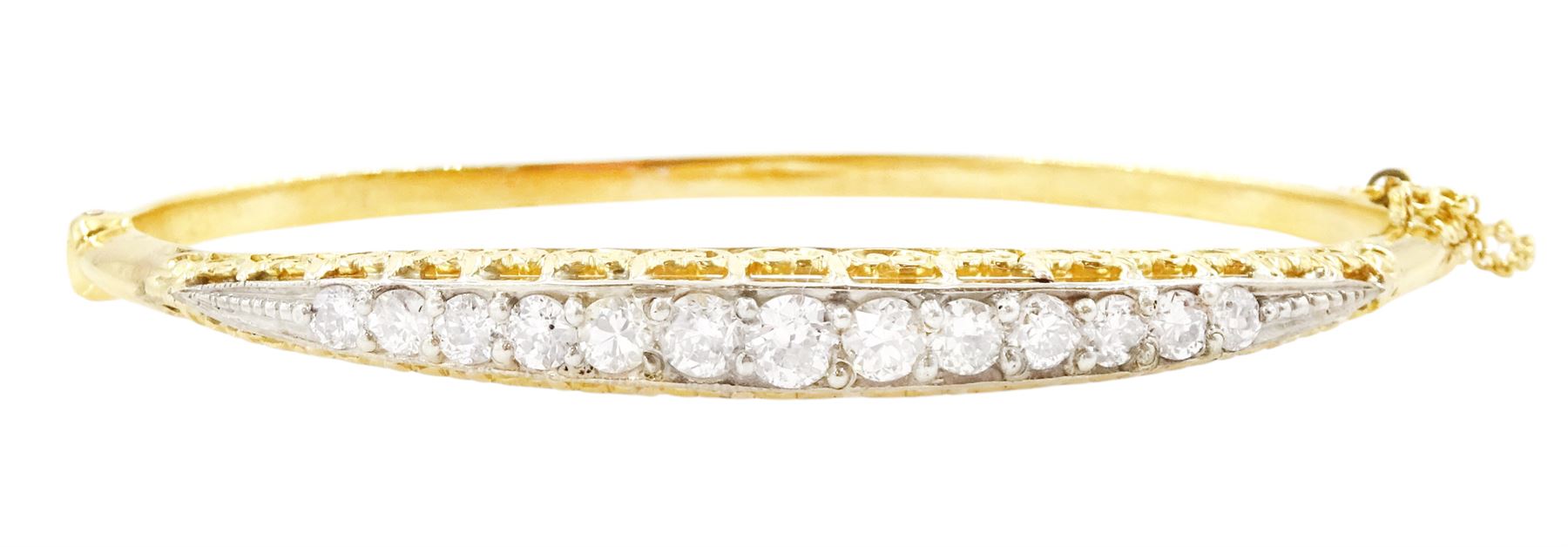 Early 20th century gold and silver diamond hinged bangle, thirteen graduating old cut diamonds, within a fancy scroll design gallery, total diamond weight approx 2.10 carat