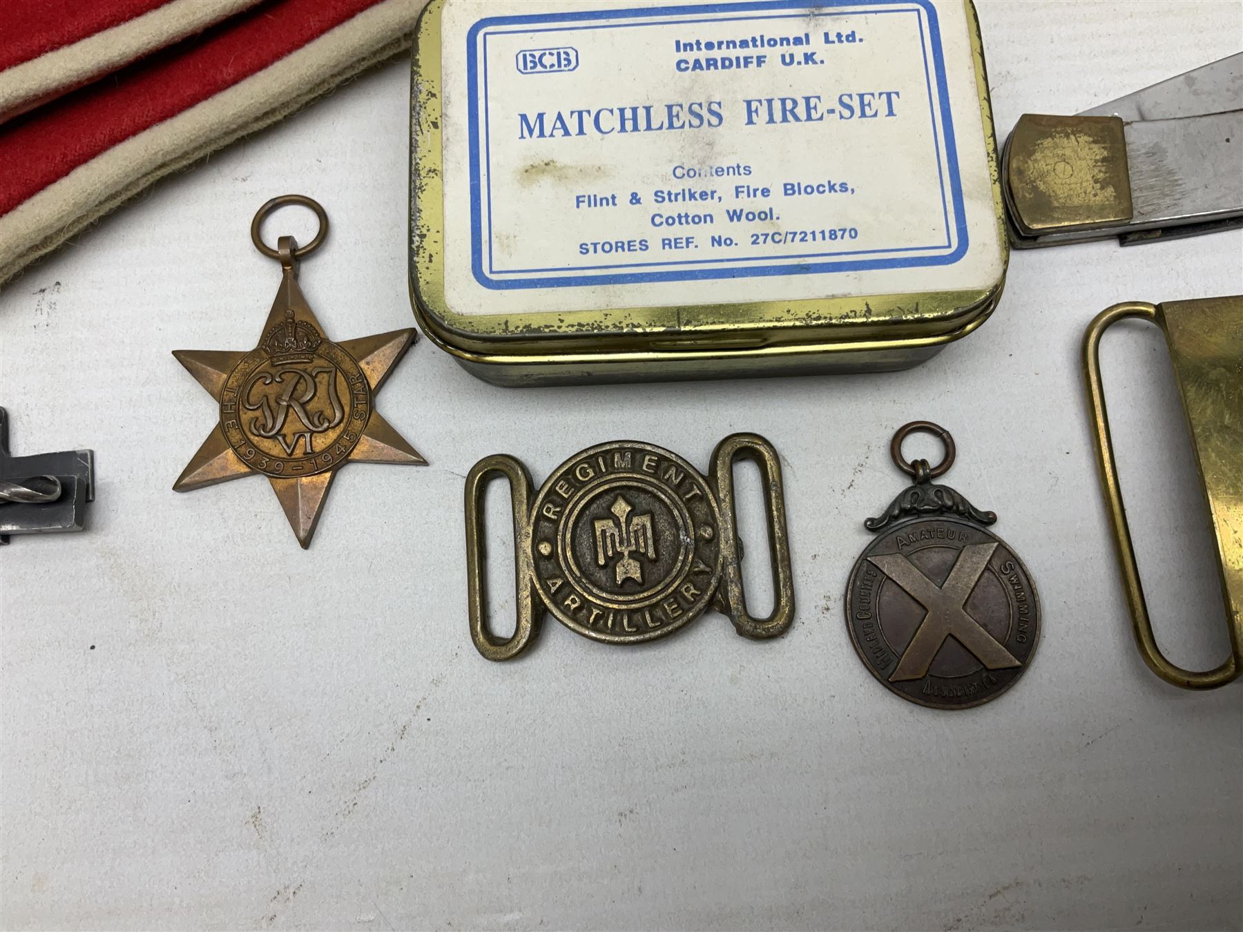 Miscellaneous militaria including two Royal Artillery and one Royal Horse Artillery stable belts; Northamptonshire Regiment trench art brass shell case lighter; unused Matchless Fire-Set; pocket knives and multi-tool; lanyards; oak shield with York & Lancaster crest etc