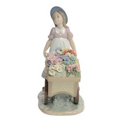 Lladro, Love's tender tokens girl, with floral filled wheelbarrow, model 6521, H23cm