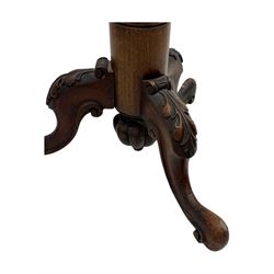 Late 19th century mahogany torchère stand, with circular top above a twisted and foliate carved collumn, on a scroll carved tripod base, on cabriole legs
