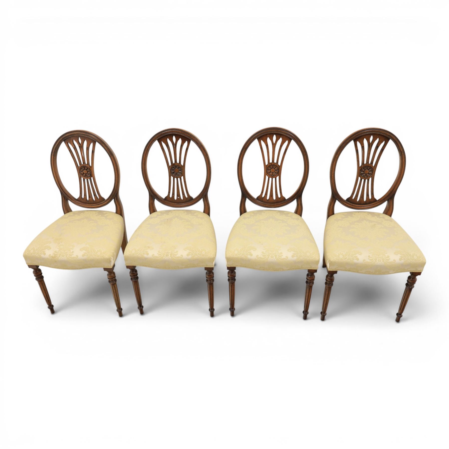 Bevan Funnell Reprodux - Regency design set of ten mahogany dining chairs, oval backs with central splat with rose motif, serpentine seat upholstered in damask fabric, raised on turned supports