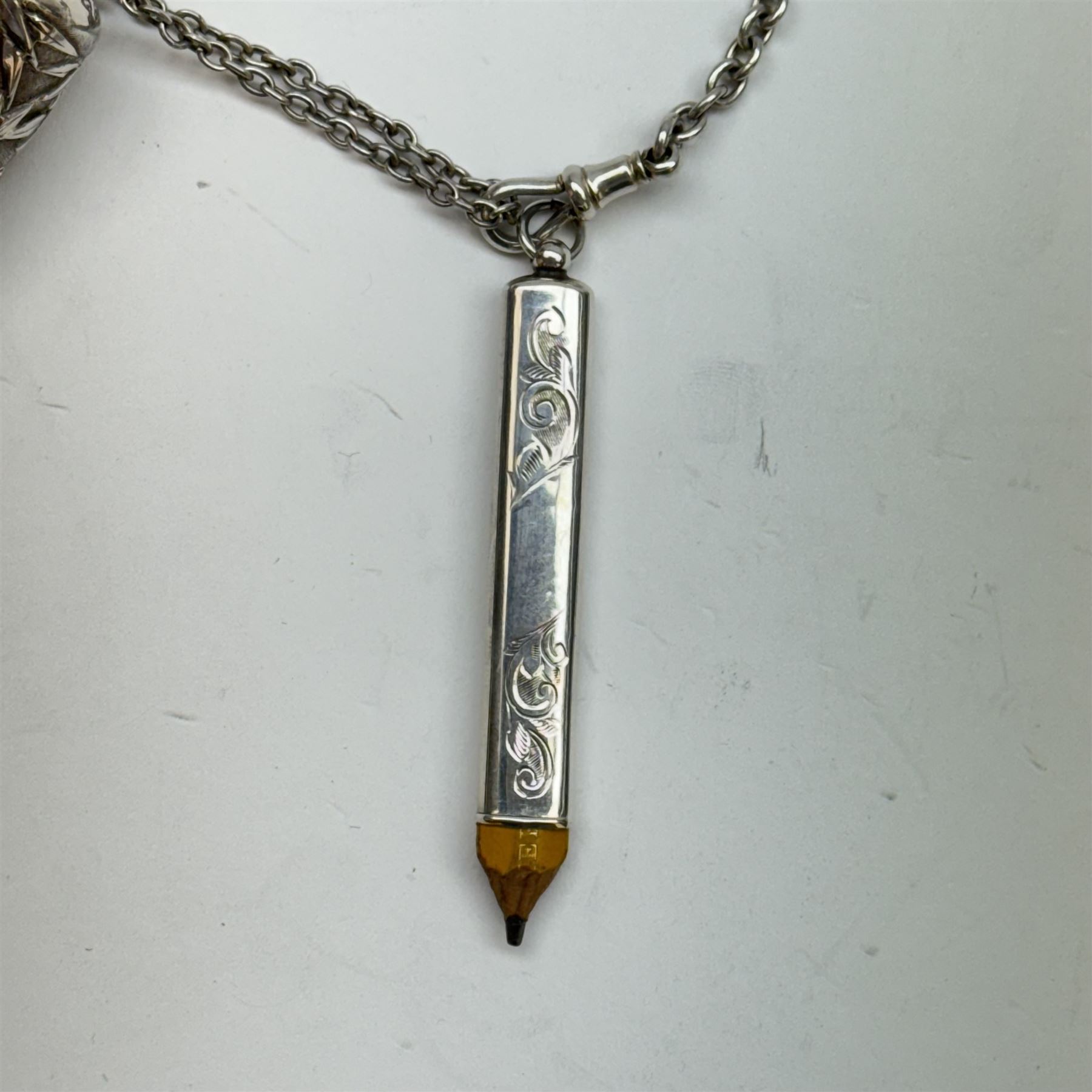 Victorian and later silver chatelaine, the shaped and foliate pierced clasp with embossed oval panel of a courting couple, hallmarked Levi & Salaman, Birmingham 1899, supporting six accessories on five chains: a circular mirror embossed with putti, hallmarked Henry Matthews, Birmingham 1911, pencil holder engraved with foliate scrolls, hallmarked Francis Webb, Birmingham 1914, conical scent bottle decorated with bamboo, (unmarked but testing as silver), aide memoire embossed with putti, hallmarked Samuel M Levi, Birmingham 1911, tape measure of compressed spherical form, hallmarked Henry Matthews, Birmingham 1899, and a purse with embossed putti, hallmarked Birmingham 1909, makers mark worn and indistinct, at longest point L31cm

