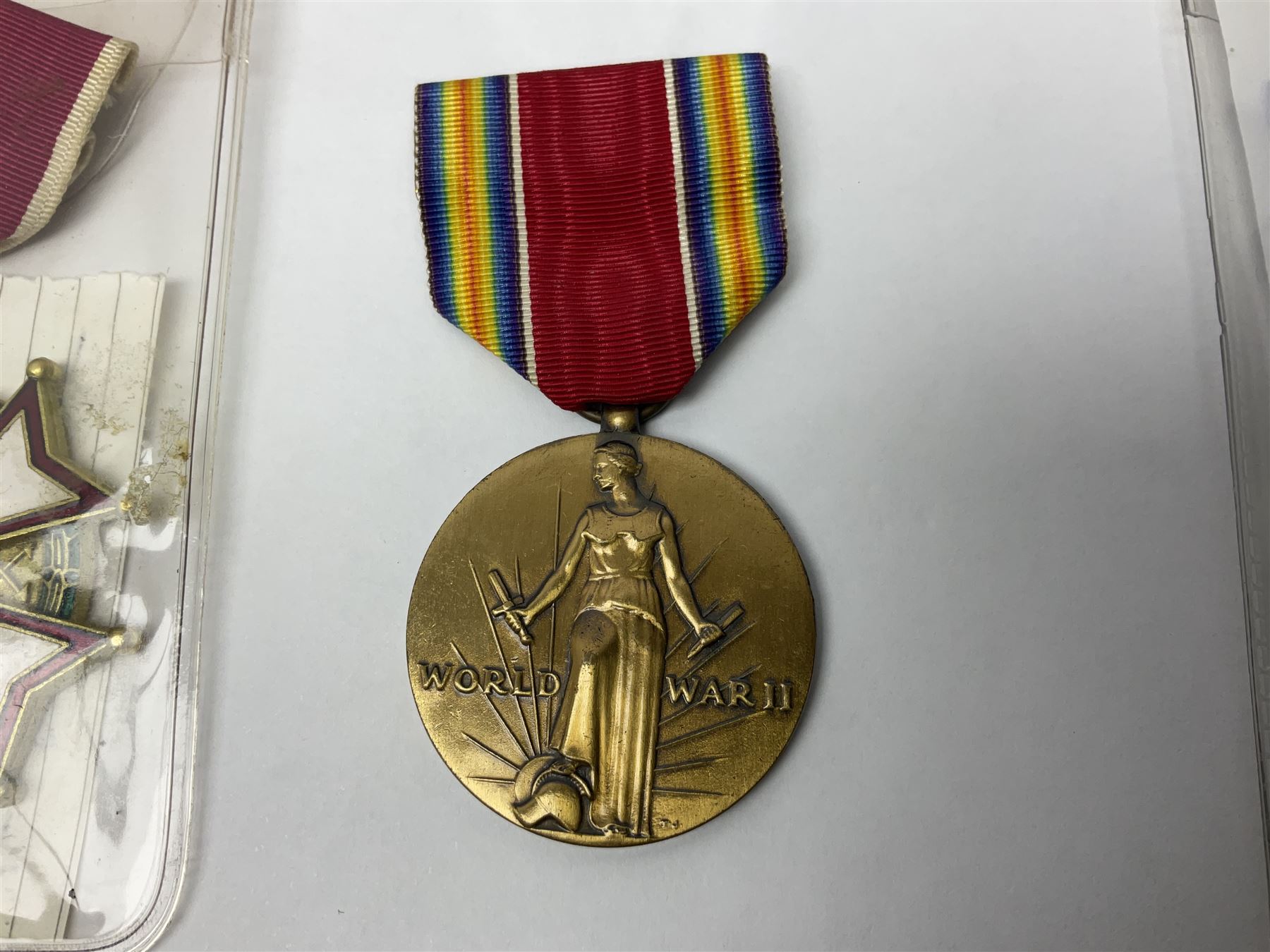 Nine American medals comprising Legion of Merit, Distinguished Flying Cross, Purple Heart named to Dick L. Sparman, Navy Good Conduct Medal, National Defence Service Medal, Army Commendation Medal, two WWII Victory Medals and China Medal; all with ribbons (9)
